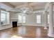 Spacious living area featuring hardwood floors, built-in window seats, and a fireplace at 3769 Baxley Point Dr, Suwanee, GA 30024