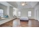Spacious main bedroom featuring tray ceiling, hardwood floors, and a large window at 3769 Baxley Point Dr, Suwanee, GA 30024