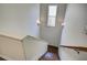 Staircase showcasing hardwood steps and decorative wall sconces at 3769 Baxley Point Dr, Suwanee, GA 30024