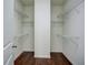 Spacious walk-in closet with hardwood floors and shelving on each side at 3769 Baxley Point Dr, Suwanee, GA 30024