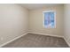 Bedroom with plush carpet, window and neutral colored walls at 112 Oakland Blvd, Stockbridge, GA 30281