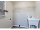 A laundry room with a utility sink and wire rack at 112 Oakland Blvd, Stockbridge, GA 30281