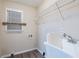 A laundry room includes a utility sink, a window, and wire shelving at 112 Oakland Blvd, Stockbridge, GA 30281