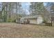 Wide backyard with mature trees, minimal foliage, deck, siding and gutters at 2102 Red Berry Sw Ln, Marietta, GA 30008