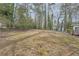 Expansive backyard with mature trees and minimal foliage, offering serene privacy and natural beauty at 2102 Red Berry Sw Ln, Marietta, GA 30008