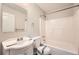 The bathroom features a shower and tub combination, vanity with sink, toilet, and tiled walls at 2102 Red Berry Sw Ln, Marietta, GA 30008