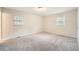 Large, bright bedroom with neutral walls, plush carpeting, and sunlit windows at 2102 Red Berry Sw Ln, Marietta, GA 30008