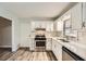 Bright kitchen with stainless steel appliances, white cabinetry, and pristine countertops at 2102 Red Berry Sw Ln, Marietta, GA 30008