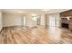Bright and airy open-concept living room features new wood floors and a classic brick fireplace at 2102 Red Berry Sw Ln, Marietta, GA 30008