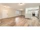 Open-concept living space with new wood floors connecting the living room and kitchen with stainless appliances at 2102 Red Berry Sw Ln, Marietta, GA 30008