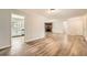 Open floorplan showing the living room, kitchen, and brick fireplace with lots of natural light and wood floors at 2102 Red Berry Sw Ln, Marietta, GA 30008