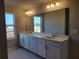 Bathroom featuring a large mirror, double sinks, and modern fixtures at 452 Eagles Nest Cir, Auburn, GA 30011