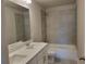 Bathroom with double sink vanity, marble tile, soaking tub, and modern fixtures at 452 Eagles Nest Cir, Auburn, GA 30011
