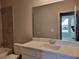 Bathroom with a large mirror, white vanity, and tiled shower over the tub at 452 Eagles Nest Cir, Auburn, GA 30011