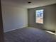 Neutral bedroom with carpeting, window overlooking the neighborhood, and ample natural light at 452 Eagles Nest Cir, Auburn, GA 30011