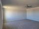 Large bedroom featuring neutral carpeting, white trim, and a ceiling fan at 452 Eagles Nest Cir, Auburn, GA 30011