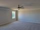 Bedroom featuring neutral carpeting, white trim, ceiling fan and ample natural light at 452 Eagles Nest Cir, Auburn, GA 30011