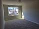 Bright bedroom featuring neutral carpeting, a large window, and ample natural light at 452 Eagles Nest Cir, Auburn, GA 30011