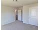Carpeted bedroom with natural light, closet, and access to the hallway at 452 Eagles Nest Cir, Auburn, GA 30011