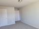 Neutral bedroom featuring neutral carpeting, white trim, and ample closet space at 452 Eagles Nest Cir, Auburn, GA 30011