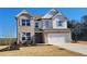 New two-story brick home with a two-car garage and freshly landscaped front yard on a sunny day at 452 Eagles Nest Cir, Auburn, GA 30011