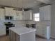 Modern kitchen featuring white cabinets, stainless steel appliances, island, and pendant lighting at 452 Eagles Nest Cir, Auburn, GA 30011