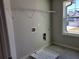 Laundry room featuring tile flooring, utility connections, and a window for natural light at 452 Eagles Nest Cir, Auburn, GA 30011