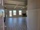 Open-concept living room featuring a brick fireplace, coffered ceilings, and light gray laminate flooring at 452 Eagles Nest Cir, Auburn, GA 30011