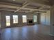 Spacious living room with a brick fireplace, coffered ceilings, and modern gray laminate flooring at 452 Eagles Nest Cir, Auburn, GA 30011