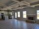 Open living space showcasing fireplace, hardwood floors, coffered ceilings, and abundant natural light at 452 Eagles Nest Cir, Auburn, GA 30011