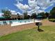 Outdoor community pool features green landscaping, ample seating, and a barbecue grill at 452 Eagles Nest Cir, Auburn, GA 30011