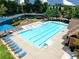 Community pool with marked lanes is accompanied by seating and green landscaping at 452 Eagles Nest Cir, Auburn, GA 30011
