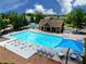Community pool includes seating and umbrellas on a sunny day for rest and relaxation at 452 Eagles Nest Cir, Auburn, GA 30011