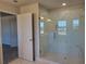 Modern glass shower featuring marble-style tile, updated fixtures and lighting at 452 Eagles Nest Cir, Auburn, GA 30011