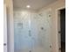 Modern glass shower featuring marble-style tile and a built-in niche at 452 Eagles Nest Cir, Auburn, GA 30011