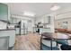 Spacious kitchen and dining area with stainless steel appliances, light-green cabinets, and hardwood floors at 510 Mountainview Dr, Covington, GA 30016