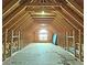 Spacious attic featuring wooden beams, flooring and natural light from a large arched window at 5780 Warren Farm Sw Rd, Powder Springs, GA 30127