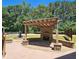Backyard view features pergola-covered fireplace and charming water fountain feature at 5780 Warren Farm Sw Rd, Powder Springs, GA 30127