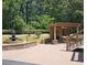 Outdoor space features pergola-covered fireplace and charming water fountain feature at 5780 Warren Farm Sw Rd, Powder Springs, GA 30127