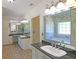 Bright bathroom featuring dual sinks with granite countertops and decorative mirrors at 5780 Warren Farm Sw Rd, Powder Springs, GA 30127