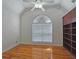 Bedroom featuring hardwood floors, an arched window, and built-in shelving at 5780 Warren Farm Sw Rd, Powder Springs, GA 30127