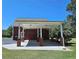 Exterior view of the brick carport connected to the house and large grassy area at 5780 Warren Farm Sw Rd, Powder Springs, GA 30127