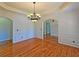 Dining room features hardwood floors, crown molding, and elegant chandelier at 5780 Warren Farm Sw Rd, Powder Springs, GA 30127