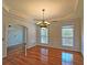 Elegant dining room with hardwood floors, decorative molding, and a chandelier at 5780 Warren Farm Sw Rd, Powder Springs, GA 30127