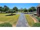 Long driveway leading to the house with a circular turn around and a well manicured lawn at 5780 Warren Farm Sw Rd, Powder Springs, GA 30127