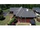 Side view of a brick house highlighting the spacious backyard and large windows at 5780 Warren Farm Sw Rd, Powder Springs, GA 30127