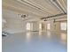 Spacious garage with neutral colored epoxy floors and large storage cabinets at 5780 Warren Farm Sw Rd, Powder Springs, GA 30127