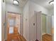 Hallway view features hardwood floors and arched doorways to nearby rooms at 5780 Warren Farm Sw Rd, Powder Springs, GA 30127