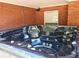 Backyard includes a large hot tub on the patio with brick surround at 5780 Warren Farm Sw Rd, Powder Springs, GA 30127