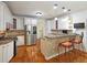 Modern kitchen with granite countertops, stainless steel appliances, and a breakfast bar at 5780 Warren Farm Sw Rd, Powder Springs, GA 30127